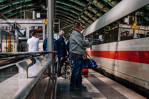 person people standing near train train