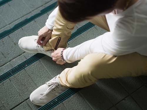 person person sitting and zipping his yellow pants people