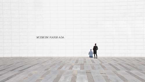 person person standing and facing white painted wall floor