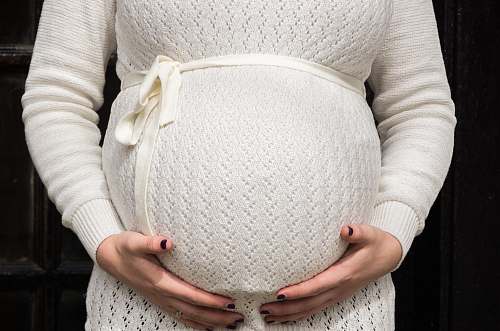 person pregnant woman holding her tummy during daytime people