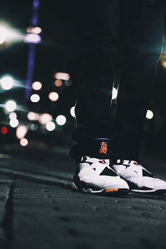 person shallow focus photography of person wearing Air Jordan 8's standing on gray concrete floor toronto