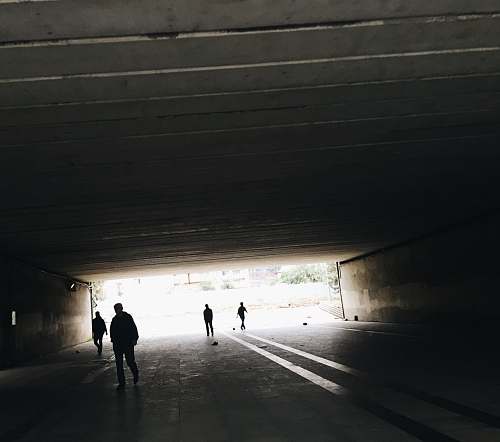 person silhouette of person standing on tunnel tunnel