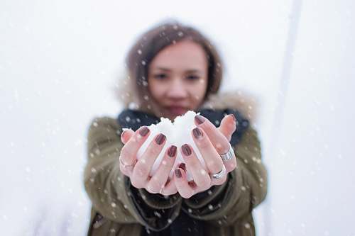 person woman holding snow at daytime people