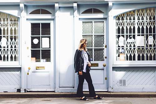 people woman standing beside the door person