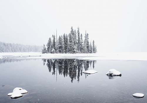 rock snowfield and body of water water