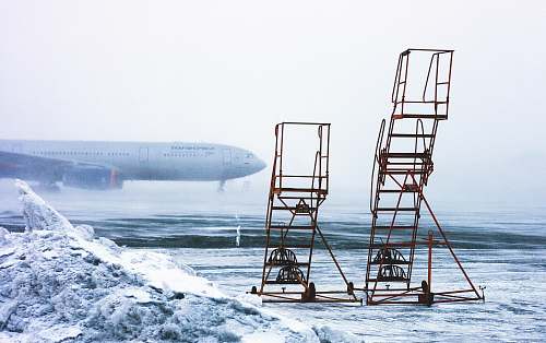 snow time lapse photography of airplane on runway chair