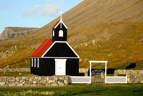 westfjords black and red church near mountain ranges church