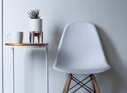 furniture round white and brown wooden table near chair table