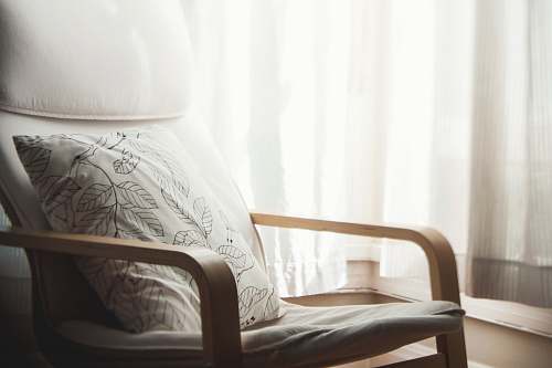 pillow white and grey leaf-printed pillow on armchair furniture