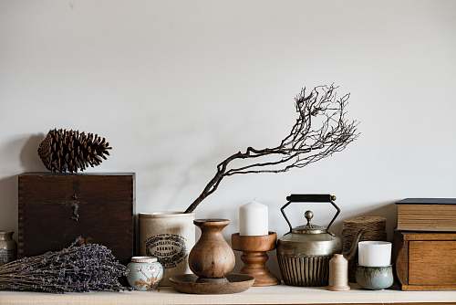 objects white pillar candle on brown wooden base pots