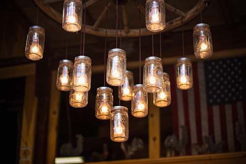 light clear glass mason jar hanging lamp turned on lighting