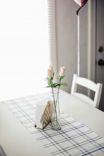 vase pink roses in glass vase in dining table pottery