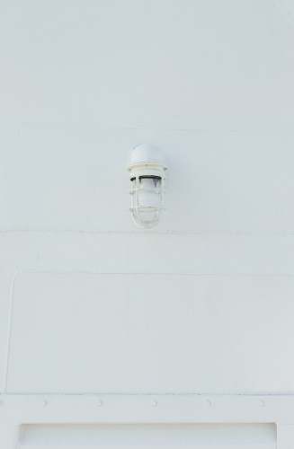 white white lamp mounted on wall grey
