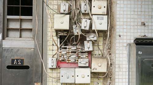 wiring several assorted power switches mounted on white wall switch