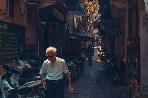 vehicle man wearing white shirt beside the motorcycle human