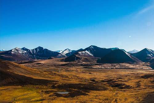 nature aerial photography of snow-capped mountain range field
