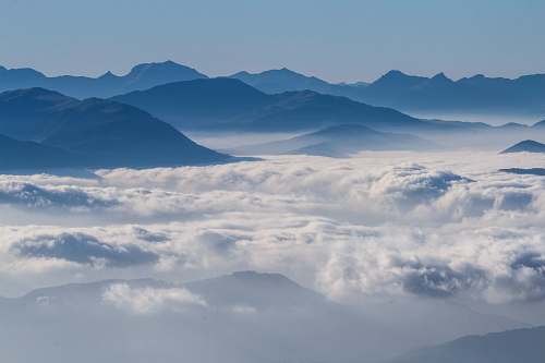 nature gray mountains surrounded by clouds in aerial photography cloud