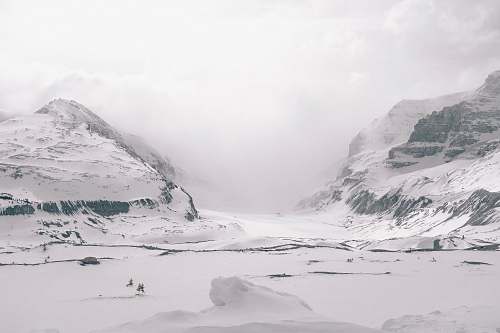 snow gray sand field and mountains glacier