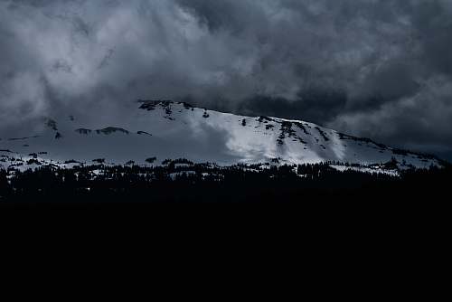 grey landscape photo of mountain during winter snow