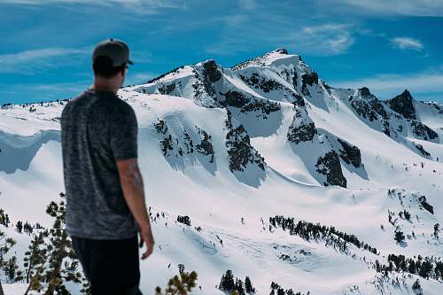 person man looking at snow mountain snow