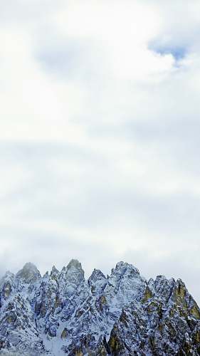 nature snow covered mountain under white clouds during daytime outdoors