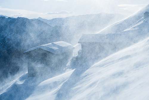 snow two cabins covered with snow ice