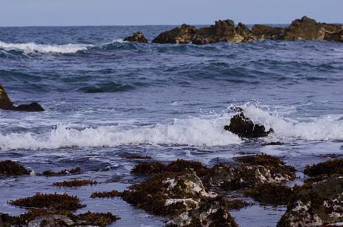 ocean body of water near rocks sea