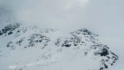 mountain gray rock covered with white snow grey