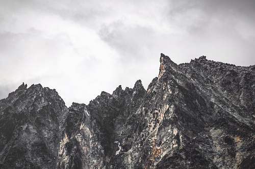 outdoors gray rocky mountain under cloudy sky mountain