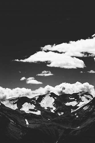 black-and-white grayscale photo of mountain and clouds mountain