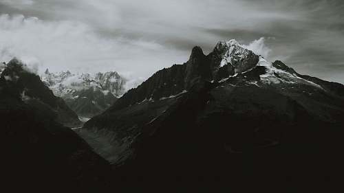 mountain grayscale photography of alps outdoors