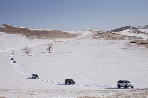 grey group of vehicles on white sand soil