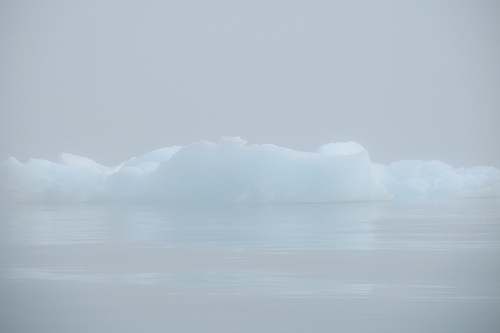 ice icebergs on body of water blue