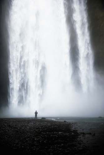 outdoors man standing in front of waterfalls water