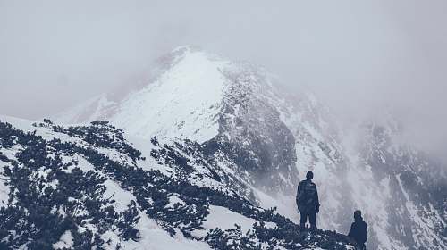 grey people standing on top of mountain mountain