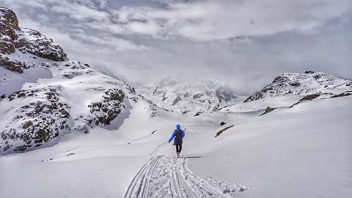 mountain person walking on snowy mountain snow
