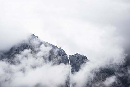mountain photo of mountain under white clouds at daytime clouds