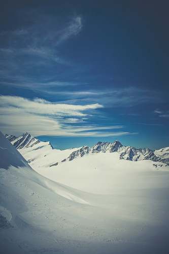 mountain snow covered mountain under blue sky glacier