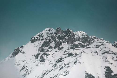mountain snowy mountain under calm blue sky mountain range