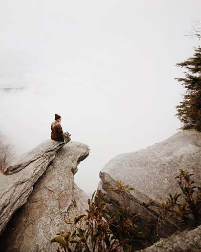 rock woman sitting on brown rock girl