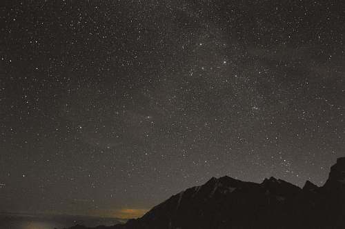 universe silhouette of mountain under gray sky stars
