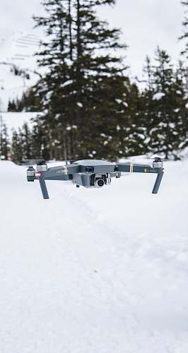 flight gray flying quadcopter near trees with snow winter