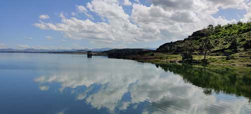 reservoir reflection of clouds on body of water during daytime veer dam