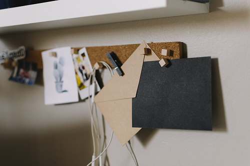 white brown cork board with papers shelf