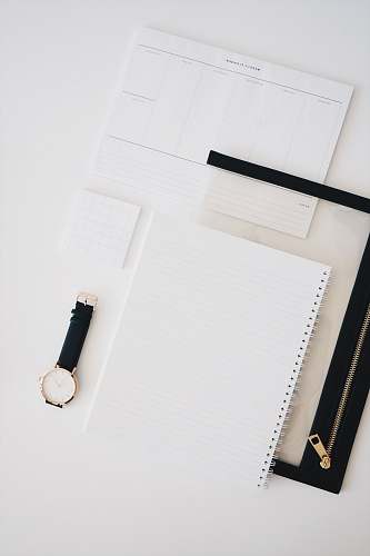 wristwatch gray lined paper on table white