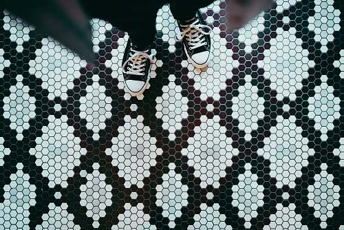 shoe person standing wearing black sneakers tiles