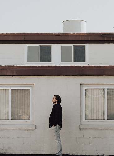 human man standing on front of residential building person