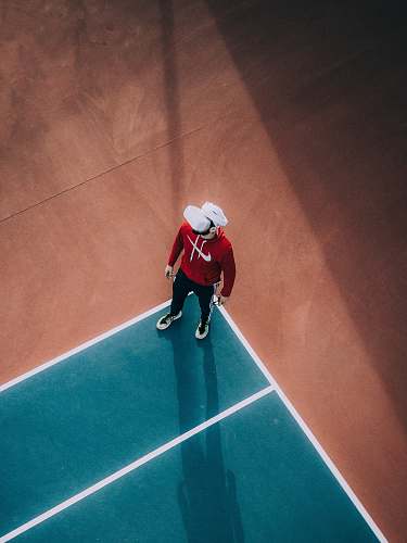 human man standing on lawn tennis court person