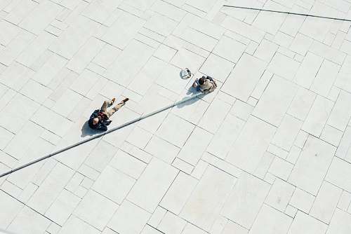 minimal person lying on white concrete pavement during daytime landscape