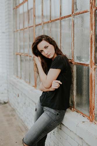woman woman and black crew-neck T-shirt lying beside glass window girl